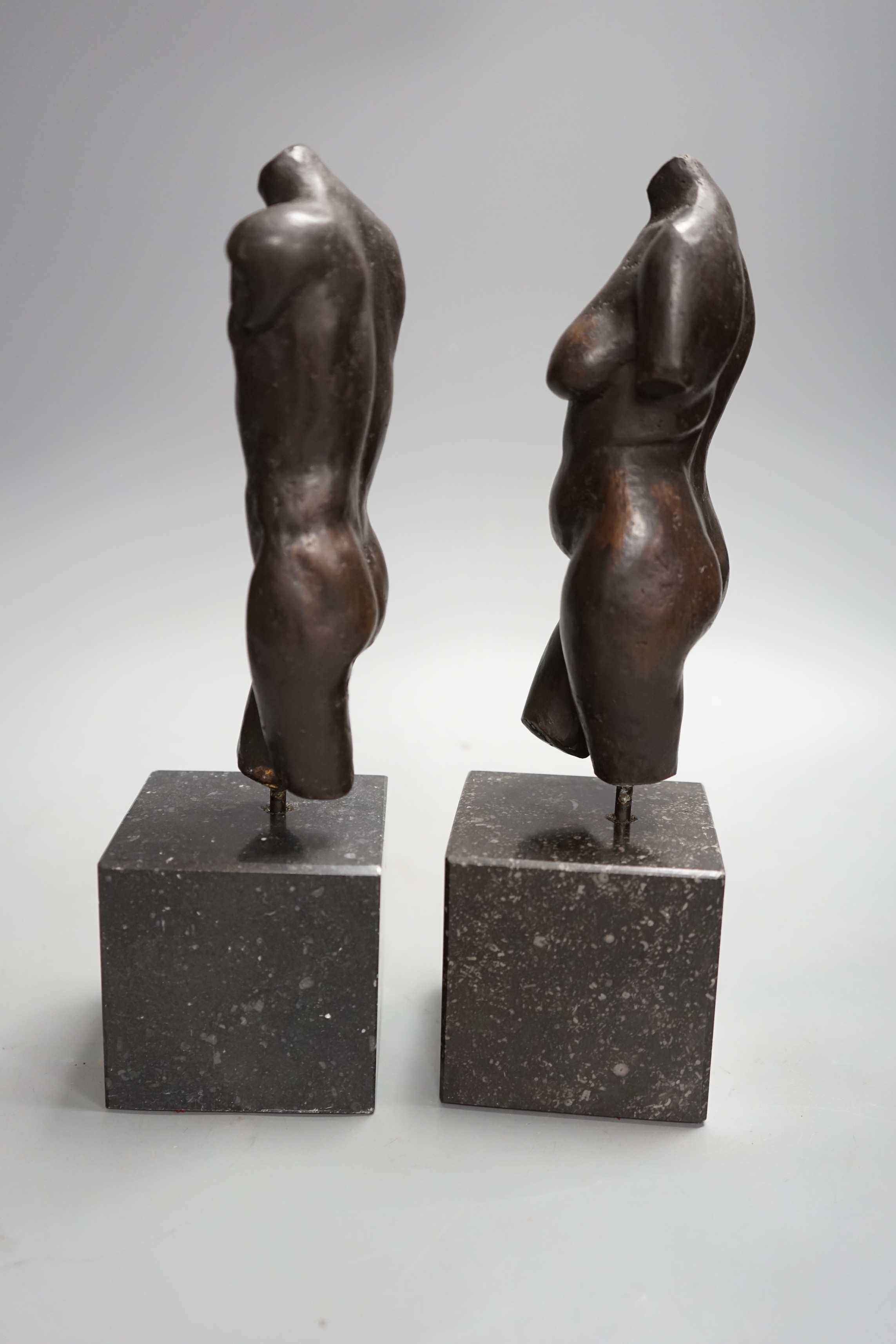 A bronze male and a female nude torso on stand (2), 27cms high